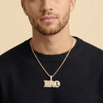 Male model wearing CRNCY's Small BRO Photo Pendant with a 14k gold finish and a 20 inch length necklace.