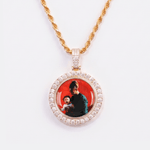 The front side of CRNCY's Double Sided Photo Pendant with a 14k gold finish. The front side features prong-set diamonds around the photo and on the bale. The front side shows the first photo choice.