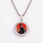 The front side of CRNCY's Double Sided Photo Pendant with a silver finish. The front side features prong-set diamonds around the photo and on the bale. The front side shows the first photo choice.