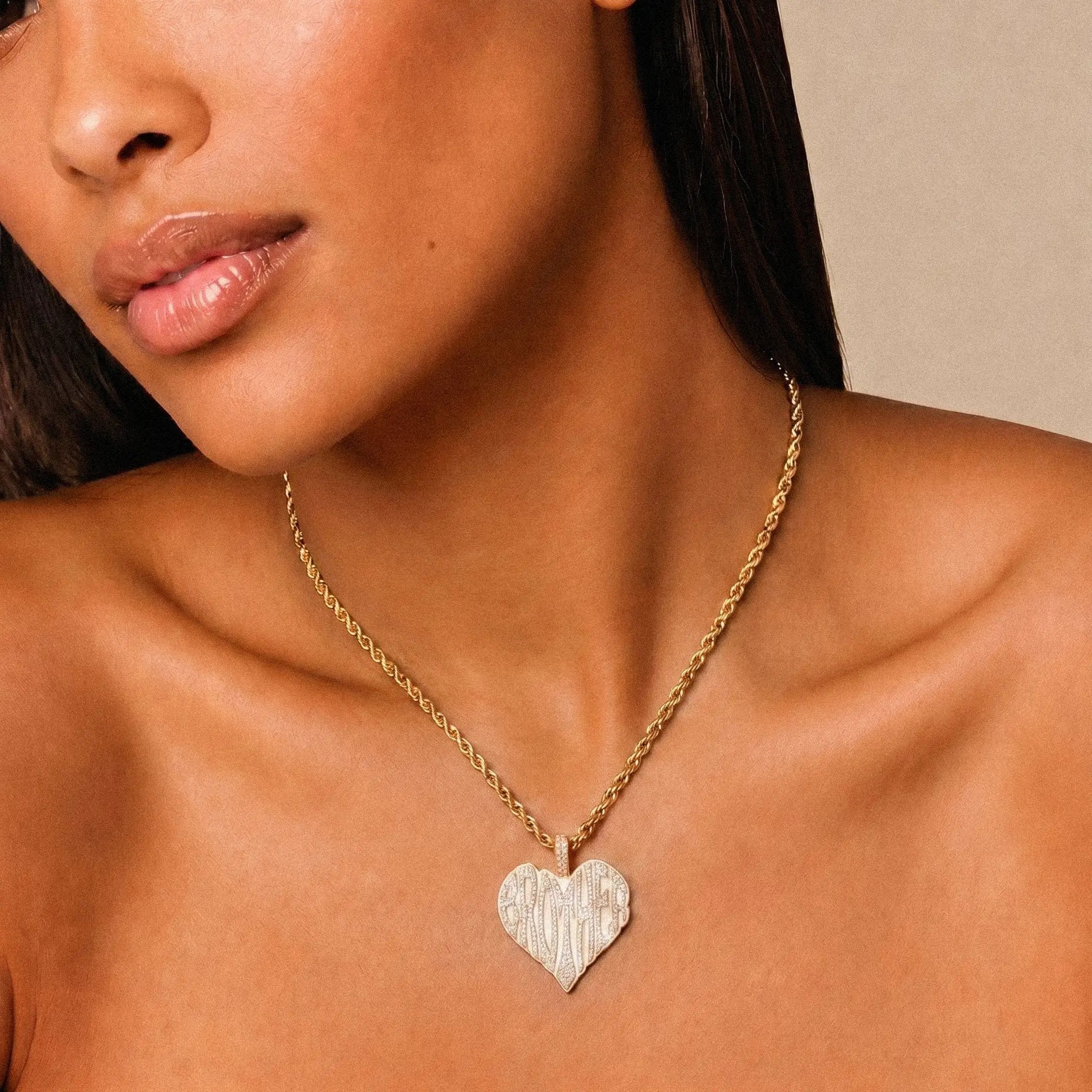 Female model wearing CRNCY's Brother Heart Photo Pendant with a 14k gold finish and a 16 inch length necklace.