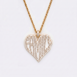 The front side of CRNCY's Family Heart Photo Pendant with a 14k gold finish. The front side features prong-set diamonds placed inside each letter, surrounded by colored jewelry enamel to outline the letters. 