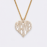 The front side of CRNCY's Mama Heart Photo Pendant with a 14k gold finish. The front side features prong-set diamonds placed inside each letter, surrounded by colored jewelry enamel to outline the letters. 