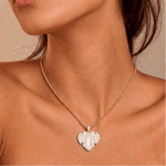 Female model wearing CRNCY's Mom Heart Photo Pendant with a 14k gold finish and a 16 inch length necklace.