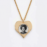 The back side of CRNCY's Sister Heart Photo Pendant. The back side has a polished appearance with a circular photo place directly in the center. The photo is selected by the customer.