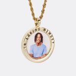 The front side of CRNCY's In Loving Memory Photo Pendant with a 14k gold finish. The front side features a polished border around the photo. "In Loving Memory" is engraved on the upper half of the photo pendant, filled with black jewelry enamel. The front side shows the customer's photo selection. 
