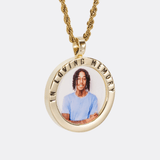 The front side of CRNCY's In Loving Memory Photo Pendant with a 14k gold finish. The front side features a polished border around the photo. "In Loving Memory" is engraved on the upper half of the photo pendant, filled with black jewelry enamel. The front side shows the customer's photo selection. 