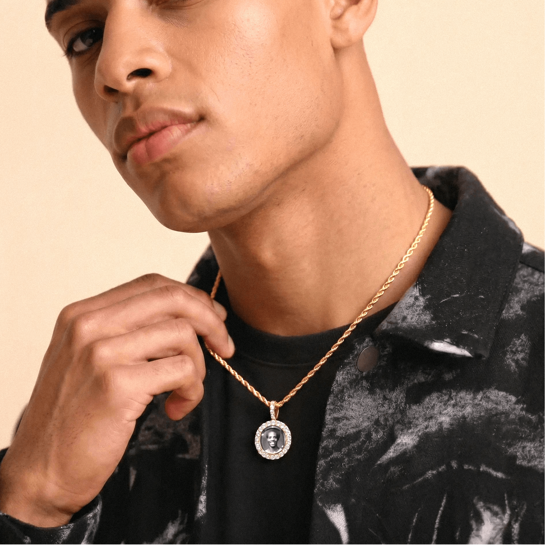 Male model wearing CRNCY's Mini Iced Photo Pendant with a 14k Gold Finish, with a 18 inch length necklace.