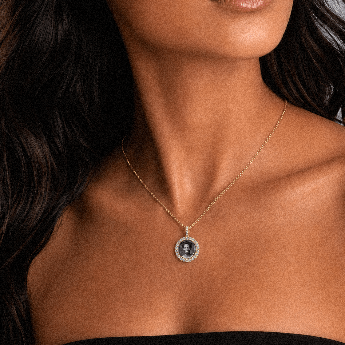 Female model wearing CRNCY's Mini Iced Photo Pendant with a 14k Gold Finish, with a 16 inch length necklace.