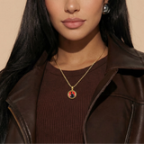 Female model wearing CRNCY's Mini Photo Pendant with a 14k Gold Finish, with a 18 inch length necklace.