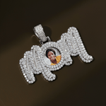 The front side of CRNCY's MOM Photo Pendant with a silver finish. The front side features prong-set diamonds around the photo and on the bale. The front side shows the customer's photo selection.