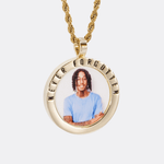 The front side of CRNCY's Never Forgotten Photo Pendant with a 14k gold finish. The front side features a polished border around the photo. "Never Forgotten" is engraved on the upper half of the photo pendant, filled with black jewelry enamel. The front side shows the customer's photo selection. 