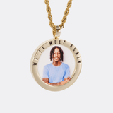 The front side of CRNCY's We'll Meet Again Photo Pendant with a 14k gold finish. The front side features a polished border around the photo. "We'll Meet Again" is engraved on the upper half of the photo pendant, filled with black jewelry enamel. The front side shows the customer's photo selection. 