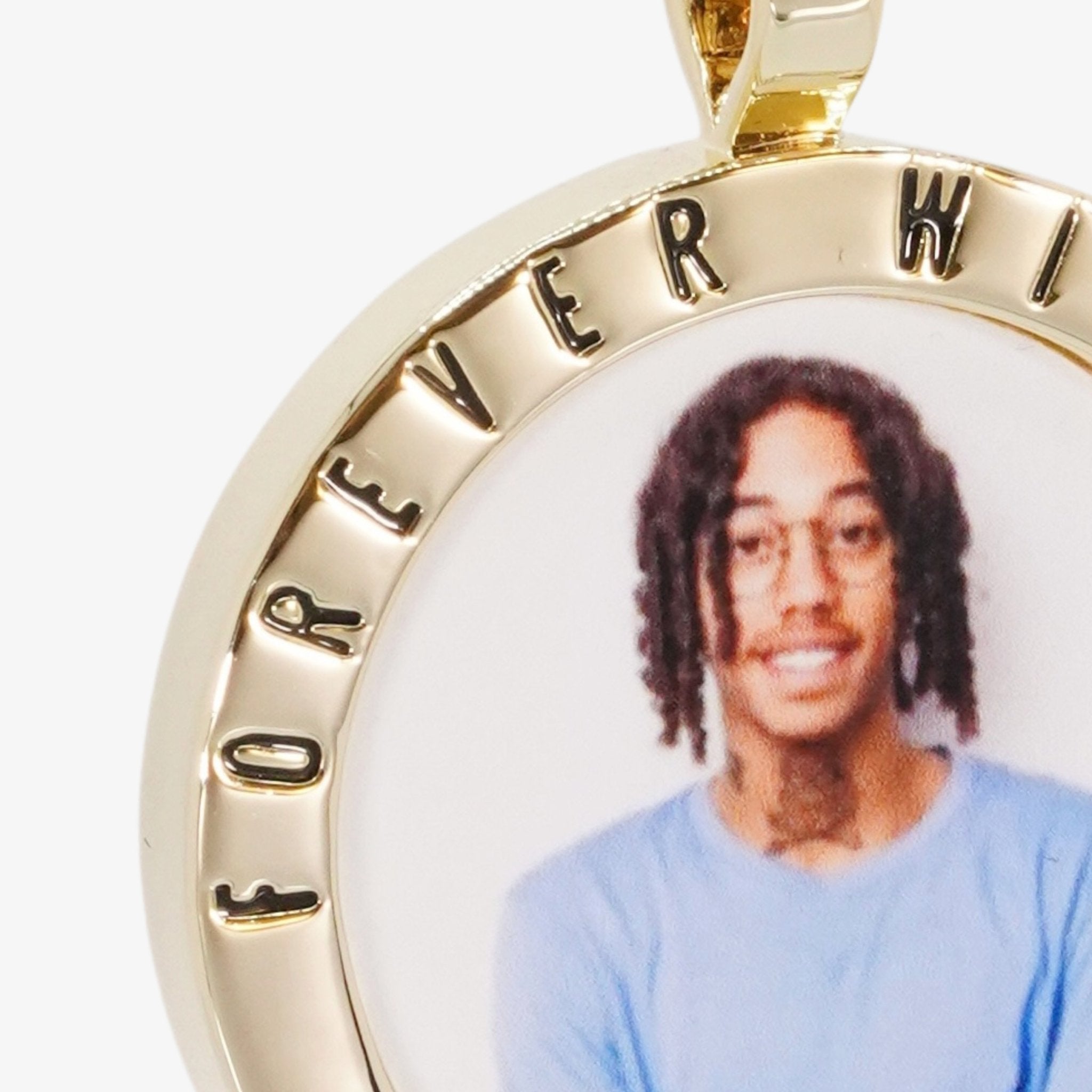 Close-up image of CRNCY's Forever With Me Photo Pendant. Focusing on the engraved words on the top of the photo pendant.