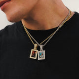 Male model wearing CRNCY's Small Framed Photo Pendant one with a 14k Gold Finish, and one with a silver finish. Both pendants are paired with 18 inch length necklaces.