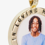 Close-up image of CRNCY's In Loving Memory Photo Pendant. Focusing on the engraved words on the top of the photo pendant.