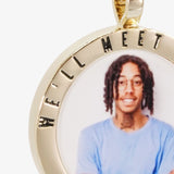 Close-up image of CRNCY's We'll Meet Again Photo Pendant. Focusing on the engraved words on the top of the photo pendant.